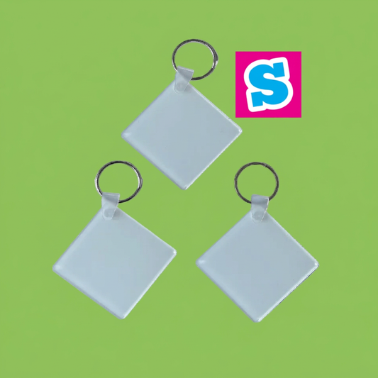 Three acrylic square sublimation keyrings with silver rings and Sublimania S logo on green background
