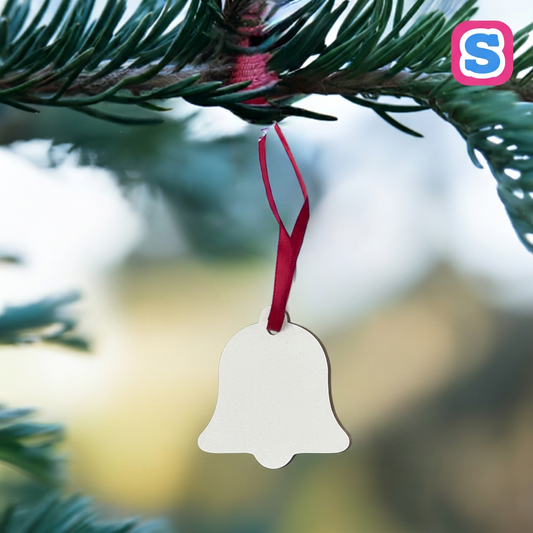 White MDF bell-shaped sublimation Christmas bauble with red ribbon and Sublimania S logo in a festive tree setting