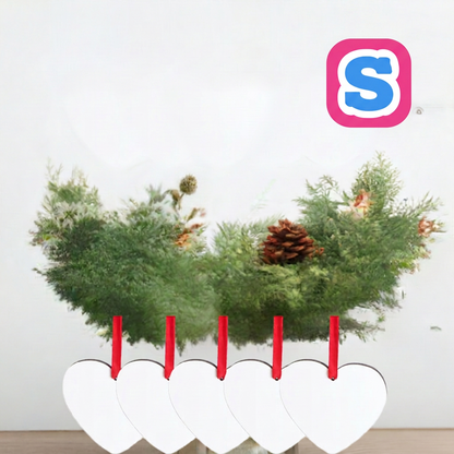 Five white heart-shaped MDF sublimation Christmas baubles with red ribbons and Sublimania S logo in a festive setting