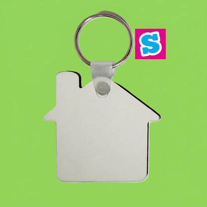 House-shaped double-sided MDF sublimation keyring with metal ring on a square green background