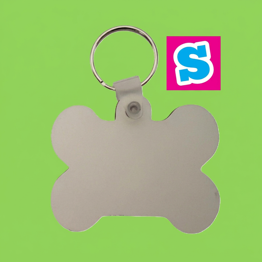 Bone-shaped MDF sublimation pet-tag keyring with silver split ring and Sublimania S logo on green background