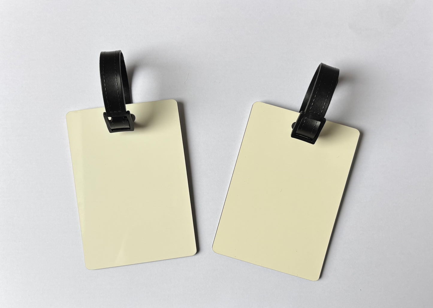 Blank double sided MDF luggage tag for sublimation printing with black strap, smooth white surface ready for custom names and designs